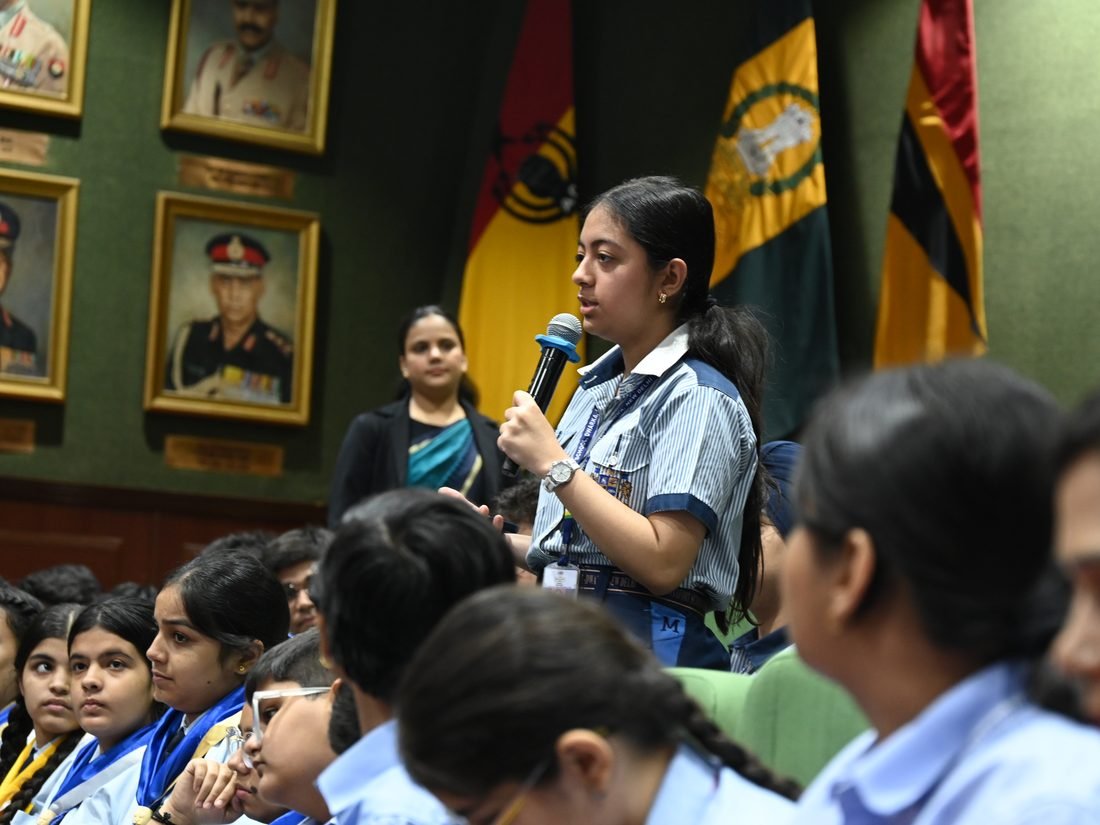 A school student stands to ask a question